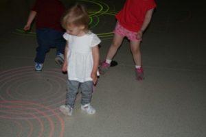 Isabelle playing with interactive floor lights