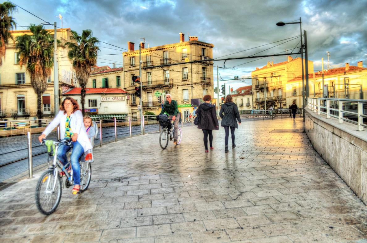 Dee Anne with daughter Kate walking parallel to Montpellier tram line as the sun begins to set WEB