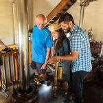 3 people checking out a steam engine