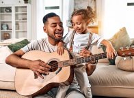 father and daughter playing guitar