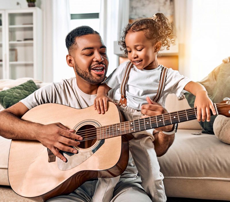 father and daughter playing guitar