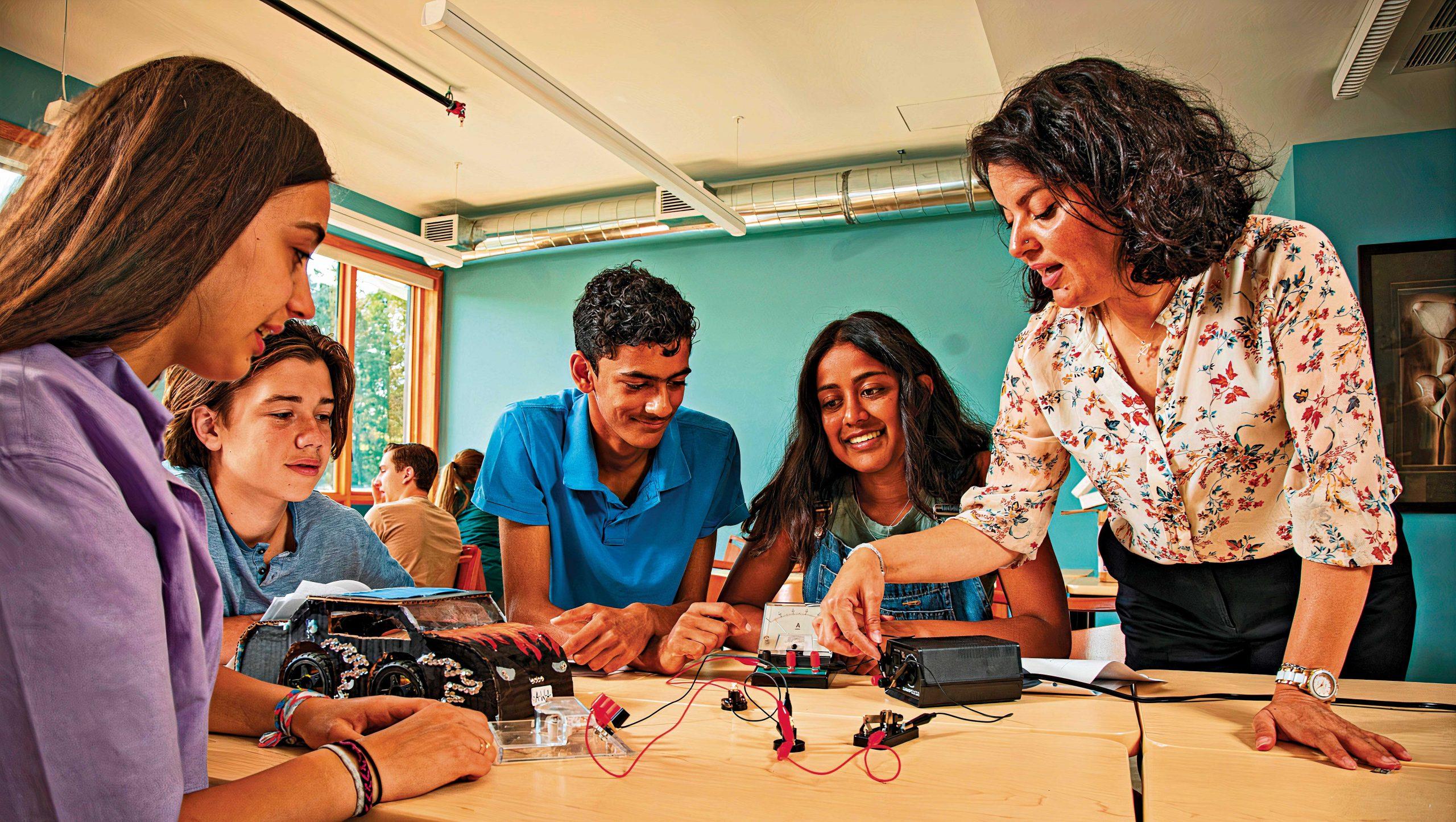 teacher with students learning about electricity