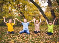 Group of kids throwing autumn leaves