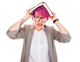girl looking worried with book on top of her head